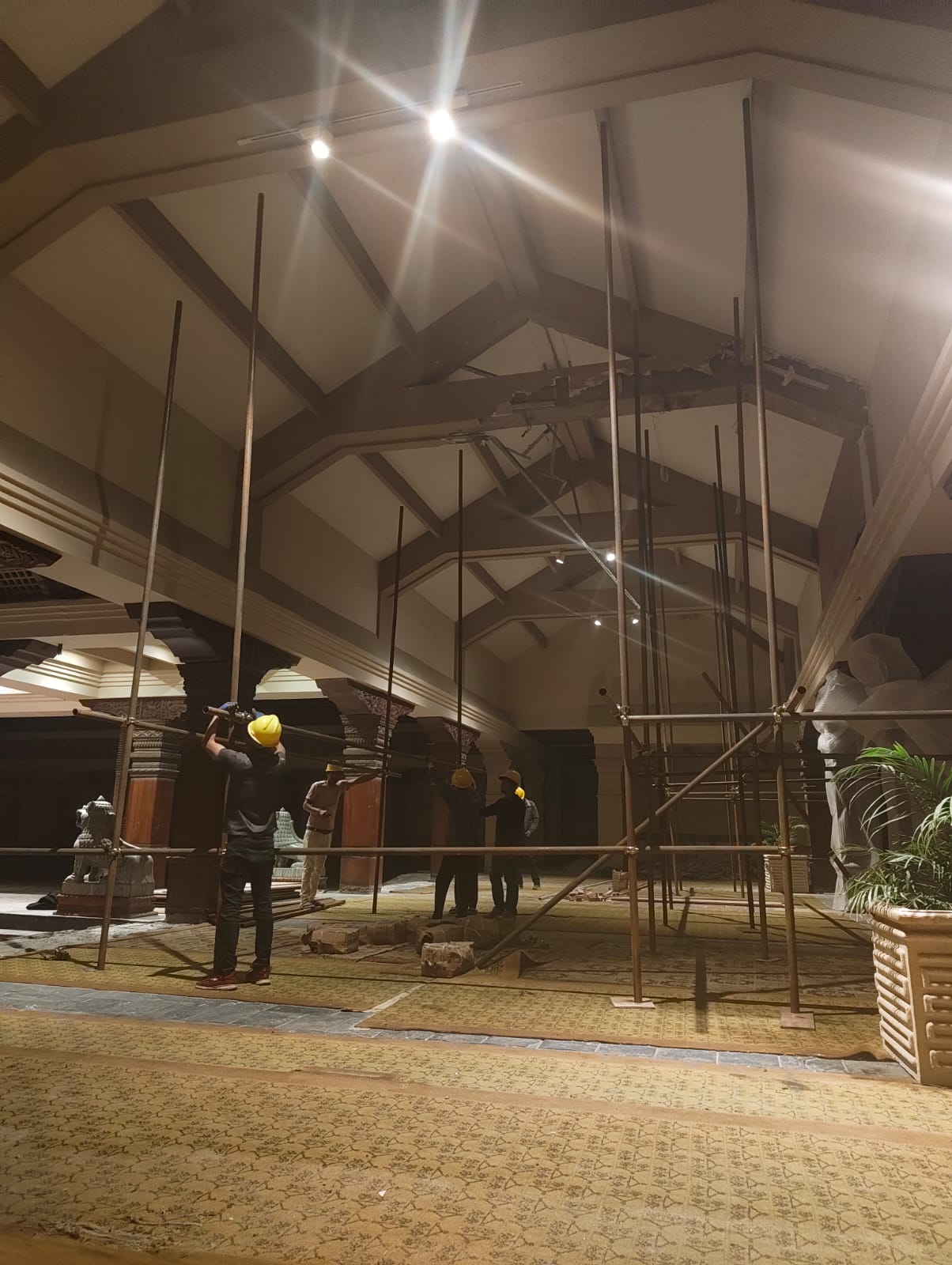 Craftsmen at work beneath a grand vaulted ceiling during fit-out